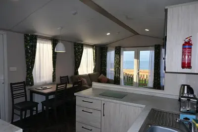 a kitchen and living room with a view of the ocean at Muasdale - Shore View in Muasdale