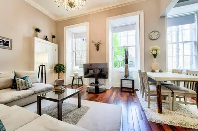 a living room with a couch and a table at Gorgeous apartment in the heart of New Town in Edinburgh