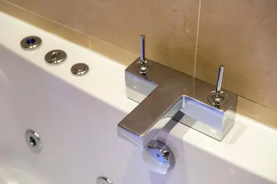 a bath tub with a metal sink in a bathroom at Gorgeous apartment in the heart of New Town in Edinburgh