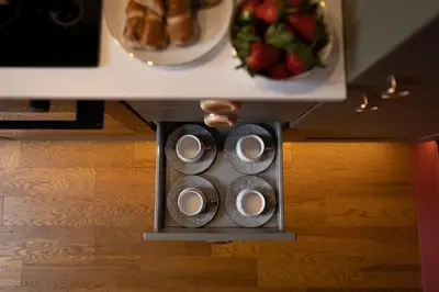a table with four cups and a plate of food at Huntly House - A Residence Like No Other in Glasgow