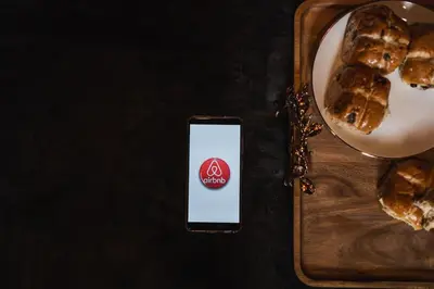 a cell phone sitting on a table next to a plate of food at Huntly House - A Residence Like No Other in Glasgow