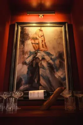 a bottle of wine sitting on a table with glasses at Huntly House - A Residence Like No Other in Glasgow