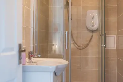 a bathroom with a shower and a sink at Ground Floor 2 Bed Flat Slateford in Edinburgh