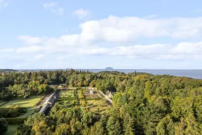 an aerial view of a park with trees and the ocean at Clocktower - Culzean Castle in Maybole