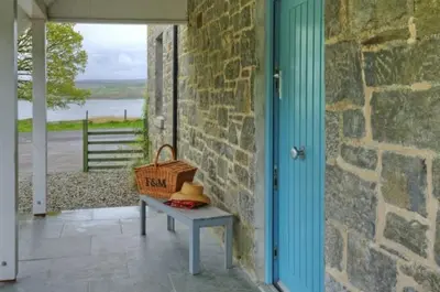 a picnic table with a basket and a hat on it at Achaglachgach Stables in Tarbert
