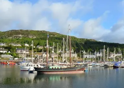 a group of boats docked in a harbor at Achaglachgach Stables in Tarbert