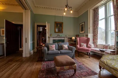 a living room with a couch and a chair at Achnacloich in Achnacloich