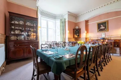 a dining room with a long table and chairs at Achnacloich in Achnacloich