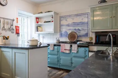 a kitchen with blue cabinets and a counter top at Achnacloich in Achnacloich