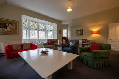a living room with a table and chairs at Achnacloich in Achnacloich
