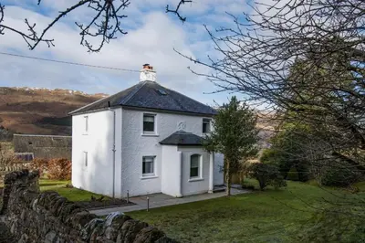 a white house with a lighthouse on top of it at Ardchyle House in Killin