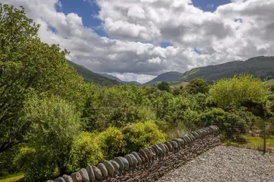 a view of a valley with mountains and trees at Branter Lodge in Strachur