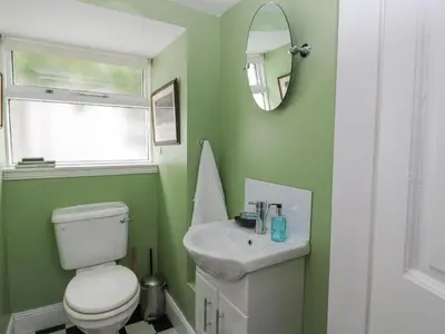 a bathroom with a white toilet and a sink at Ardchattan Manse in Oban