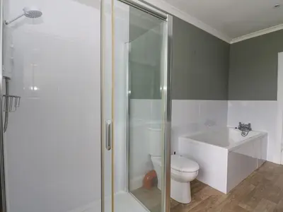 a bathroom with a shower and a toilet and a sink at Ardchattan Manse in Oban