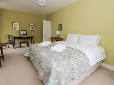 a bedroom with a bed with two towels on it at Ardchattan Manse in Oban