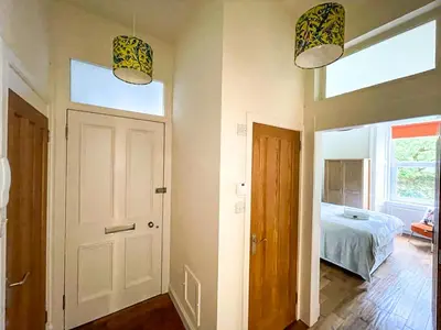 a room with a door and a bed and a window at Desirable 2 Bed Apt Near Edinburgh Castle in Edinburgh