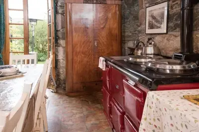 a kitchen with a stove and a counter top at Strone House in Helensburgh