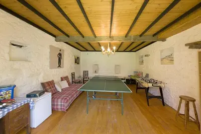 a living room with a table and a couch at Strone House in Helensburgh