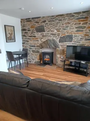 a living room with a couch and a fireplace at CRAIGLEA HEATHER in Killin