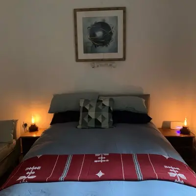 a bedroom with a large bed with two lamps at Cedarbank’s - 'Little Art House' in Kirn