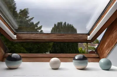 a group of eggs sitting in front of a window at Yewtree Cottage - 'The Art House' and Garden in Hunters Quay