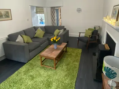 a living room with a couch and a table at Arden House in Comrie