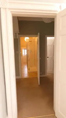 an empty room with a door and a hallway at Kirkland House B&B in Tarbert