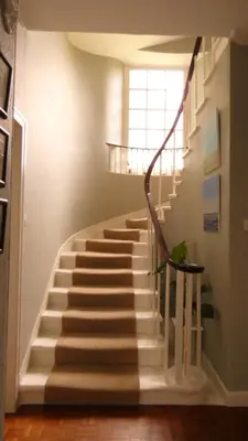 a staircase in a house with a stair case at Kirkland House B&B in Tarbert