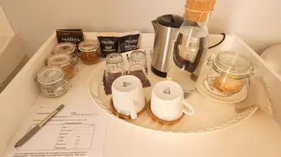 a counter top with a plate with glasses and a blender at Kirkland House B&B in Tarbert
