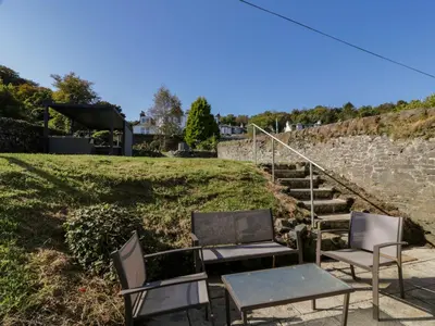 two chairs and a table and a set of stairs at Argyle House in Rothesay