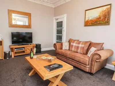 a living room with a couch and a coffee table at Argyle House in Rothesay