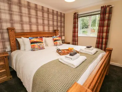 a bedroom with a large bed with towels on it at Argyle House in Rothesay