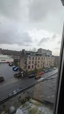 a view from a window of a parking lot with buildings at Lovely 2 Bedroom Apartment in Central Location in Greenock