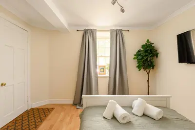 a bedroom with a bed with two pillows on it at Dean Village Hideaway by Calton Living in Edinburgh