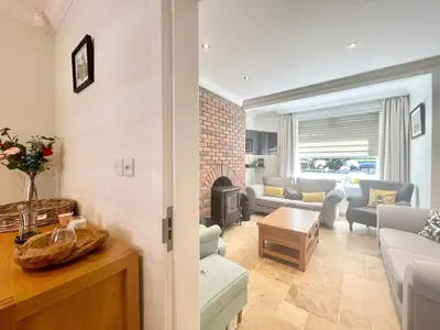 a living room with a couch and a fireplace at Clyde Villa in Glasgow