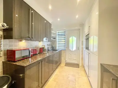 a kitchen with stainless steel cabinets and a red microwave at Clyde Villa in Glasgow