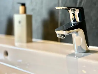 a bathroom sink with a faucet on a counter at Clyde Villa in Glasgow