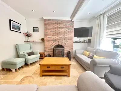 a living room with a couch and a fireplace at Clyde Villa in Glasgow