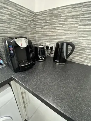 a kitchen counter with two toaster and a coffee maker at Pure Apartments Fife - Dunfermline - Pitcorthie in Dunfermline