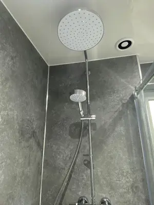 a shower with a shower head in a bathroom at Pure Apartments Fife - Dunfermline - Pitcorthie in Dunfermline