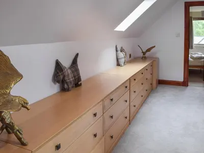 a large wooden dresser in a room at Tamarchan Lodge in Ballachulish
