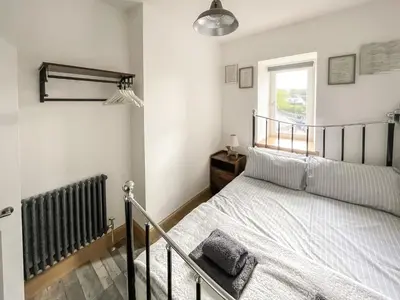 a bedroom with a bed and a window at Osborne Place in Rothesay