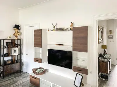 a living room with white shelves and a flat screen tv at Osborne Place in Rothesay