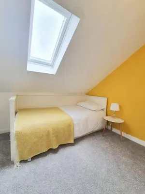 a bedroom with a bed and a window at Light & Spacious Loch Lomond Apartment in Alexandria
