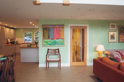 a kitchen and living room with a couch and a table at Claggan Farmhouse, Loch Tay in Aberfeldy