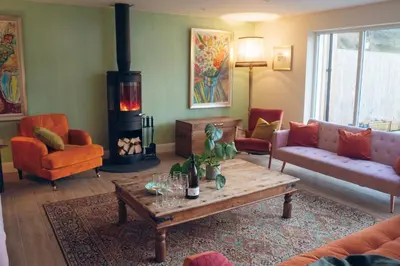 a living room with a couch and a table at Claggan Farmhouse, Loch Tay in Aberfeldy