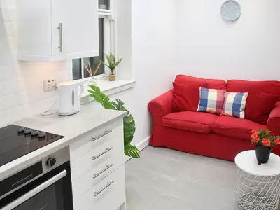 a red couch in a kitchen with a red couch at Bay View in Brodick