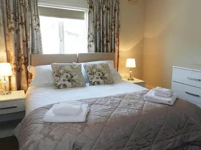 a bedroom with a bed with two towels on it at Larkfield in Lamlash