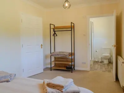 a bedroom with a bed and a toilet and a mirror at Park Lane in Auldgirth