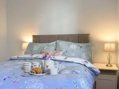 a bed with a tray of food on it at 1 Hamilton Terrace in Lamlash